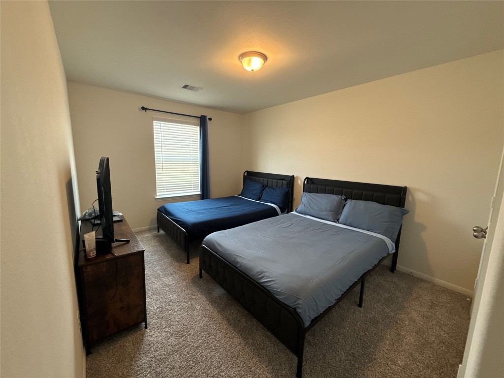 527 Baobab Way Crosby, TX 77532 - Photo 33 of 50 a bedroom with furniture and a flat screen tv