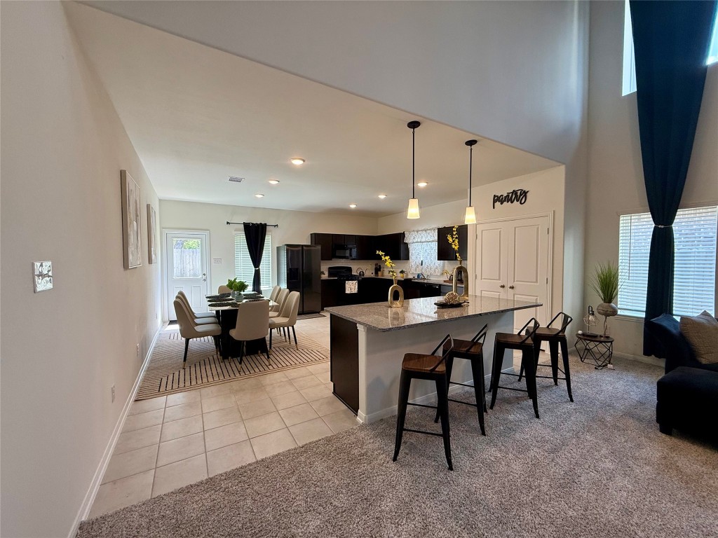 527 Baobab Way Crosby, TX 77532 - Photo 5 of 50 a kitchen with a dining table chairs and white appliances