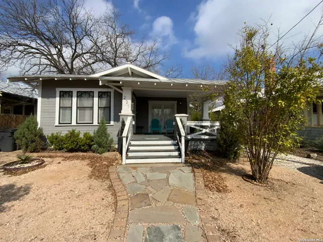 a view of a house with backyard and sitting area