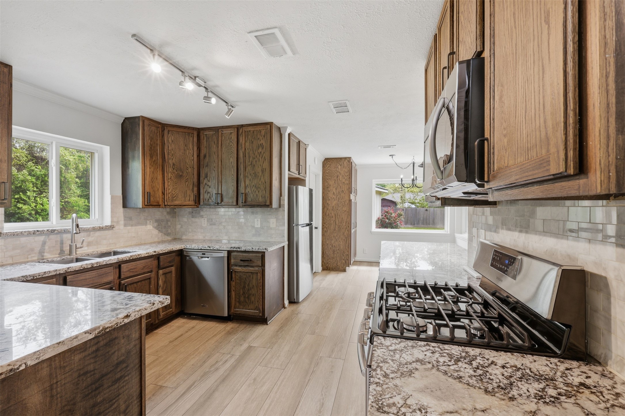 24714 Hunters Hollow Drive Spring, TX 77380 - Photo 10 of 39 The kitchen seamlessly connects to the living room, with easy access to a cozy breakfast nook on one side and a convenient home office on the other.