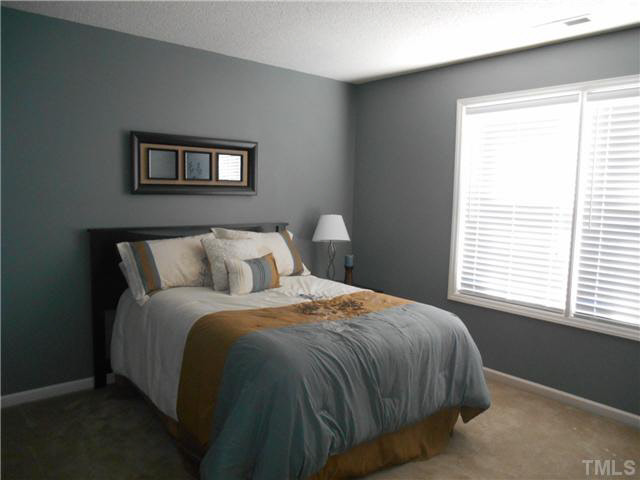 5012 Mocha Lane Raleigh, NC 27616 - Photo 13 of 14 a bed sitting in a bedroom next to a window
