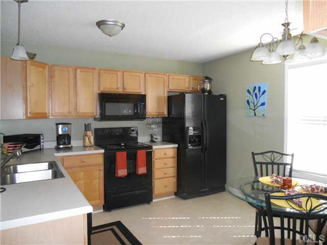 5012 Mocha Lane Raleigh, NC 27616 - Photo 3 of 14 a kitchen with stainless steel appliances granite countertop a refrigerator stove top oven a sink and dishwasher