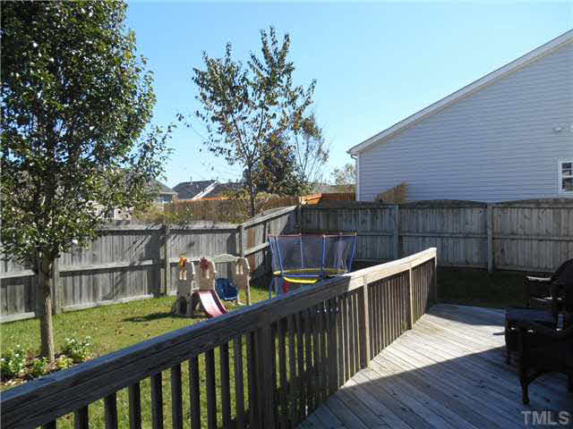 5012 Mocha Lane Raleigh, NC 27616 - Photo 8 of 14 a view of a deck with furniture and wooden fence