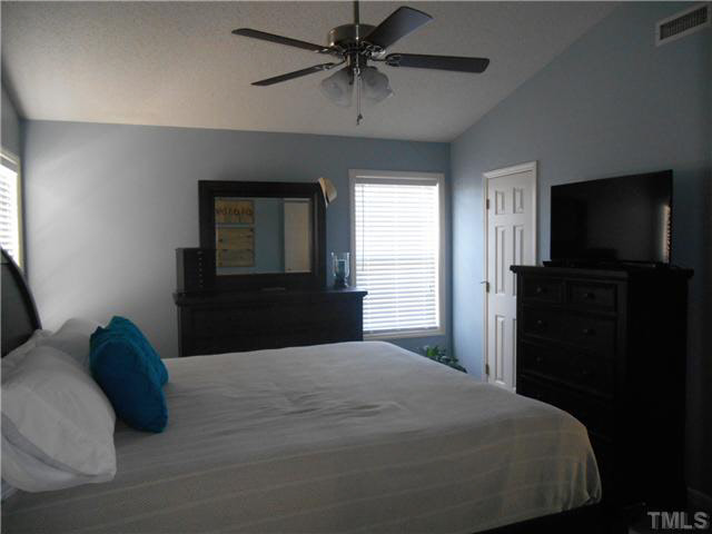 5012 Mocha Lane Raleigh, NC 27616 - Photo 10 of 14 a bedroom with a bed and a chandelier