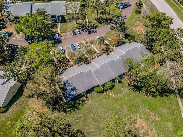 an aerial view of residential houses with outdoor space and lake view