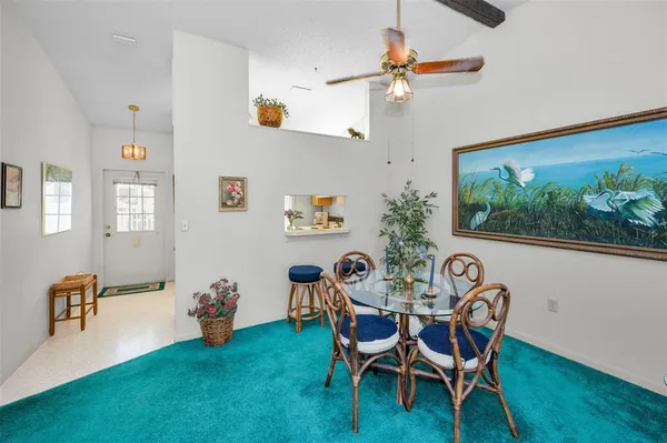 a living room with furniture a window and a flat screen tv