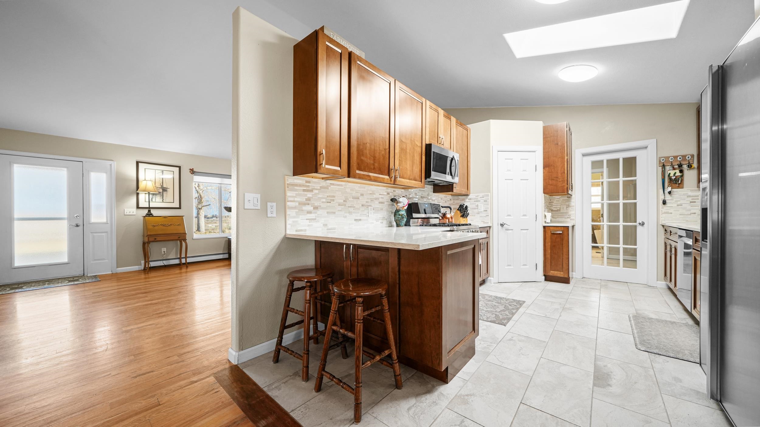 1392 M M 1/4 Road Loma, CO 81524 - Photo 11 of 42 a large kitchen with stainless steel appliances kitchen island granite countertop a stove top oven a sink a dining table and chairs