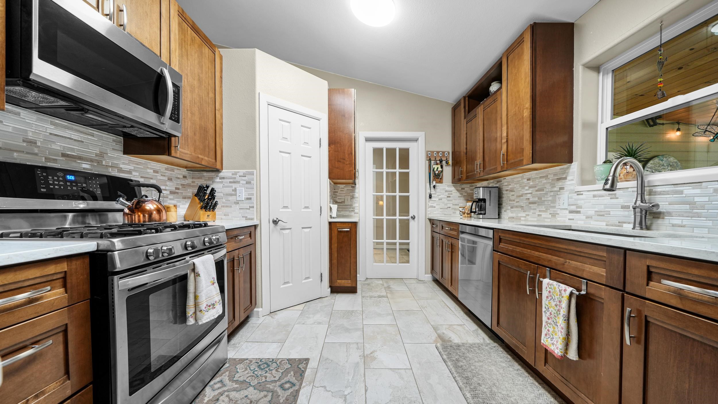 1392 M M 1/4 Road Loma, CO 81524 - Photo 12 of 42 a kitchen with stainless steel appliances granite countertop a stove microwave and sink