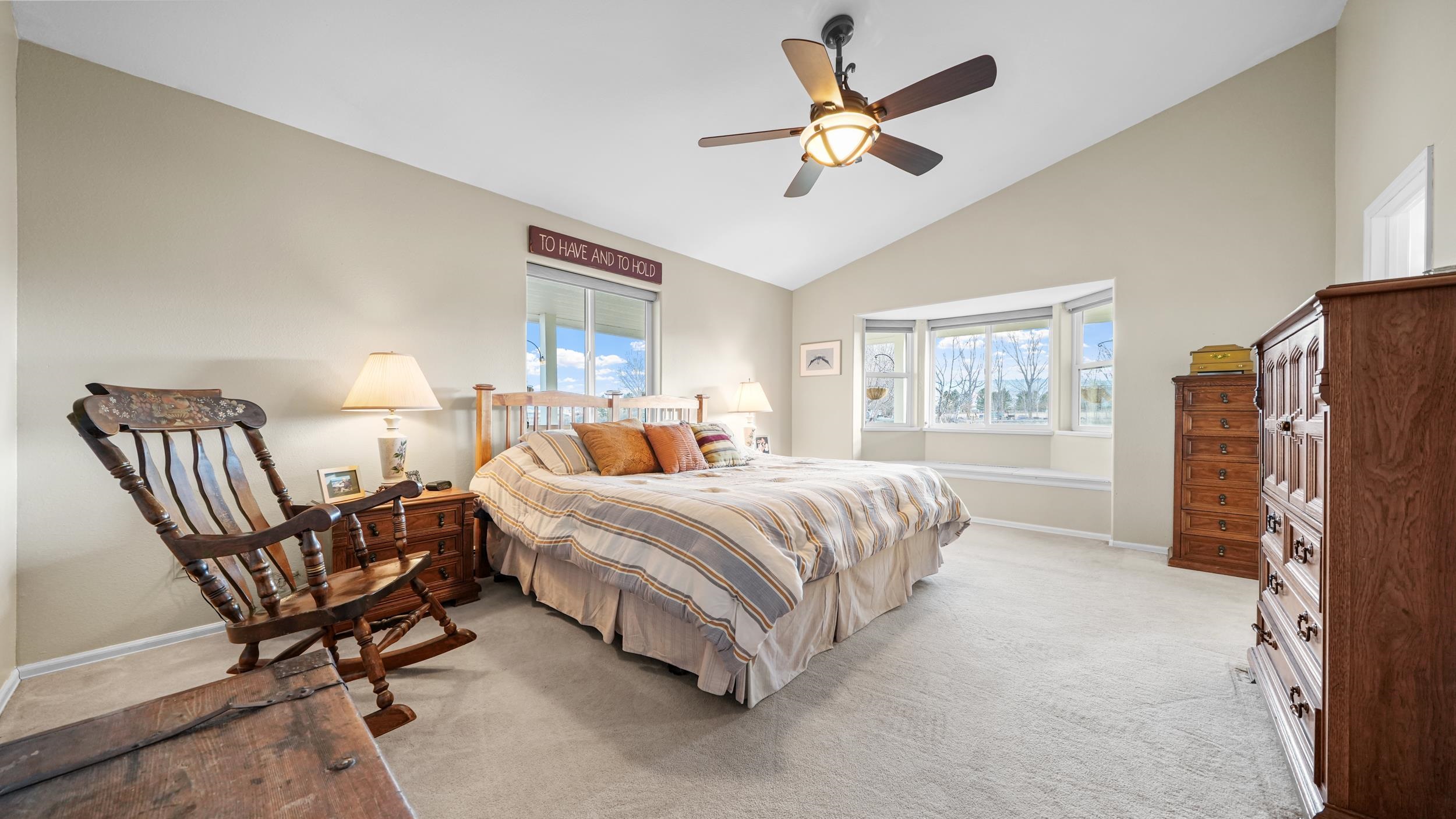 1392 M M 1/4 Road Loma, CO 81524 - Photo 16 of 42 a spacious bedroom with a bed a chandelier and a dresser