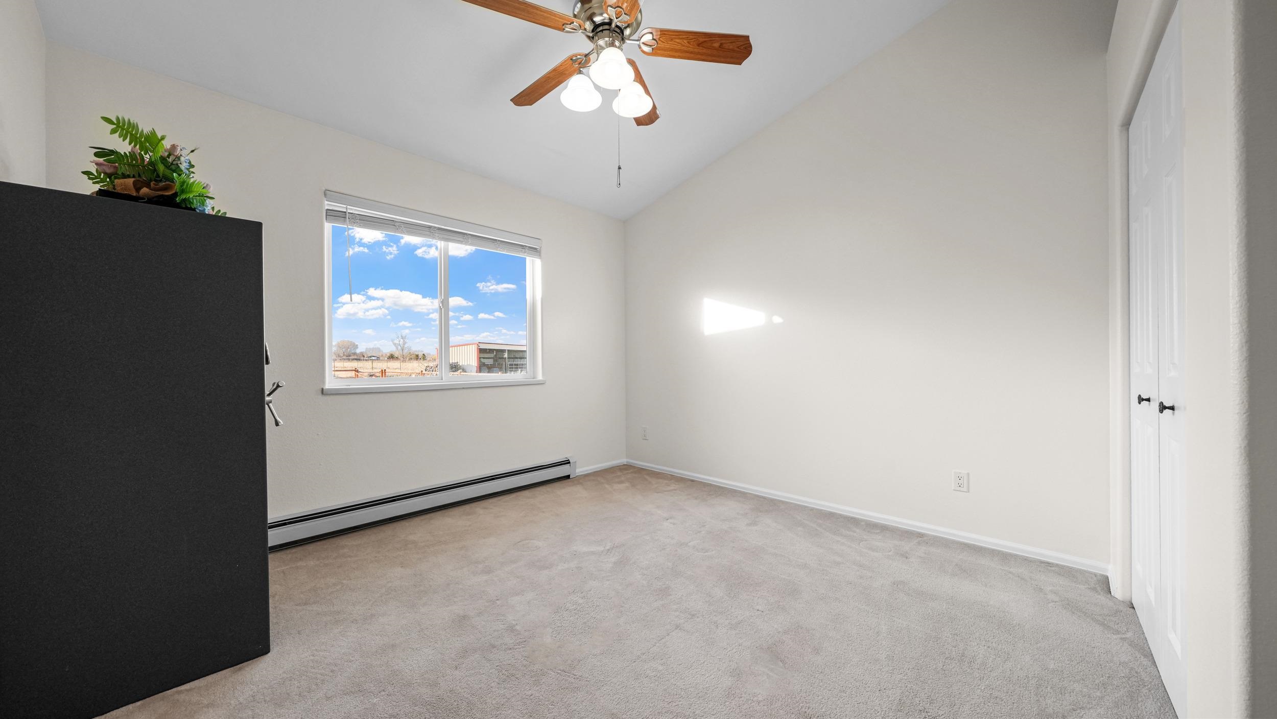 1392 M M 1/4 Road Loma, CO 81524 - Photo 19 of 42 an empty room with windows and cabinet
