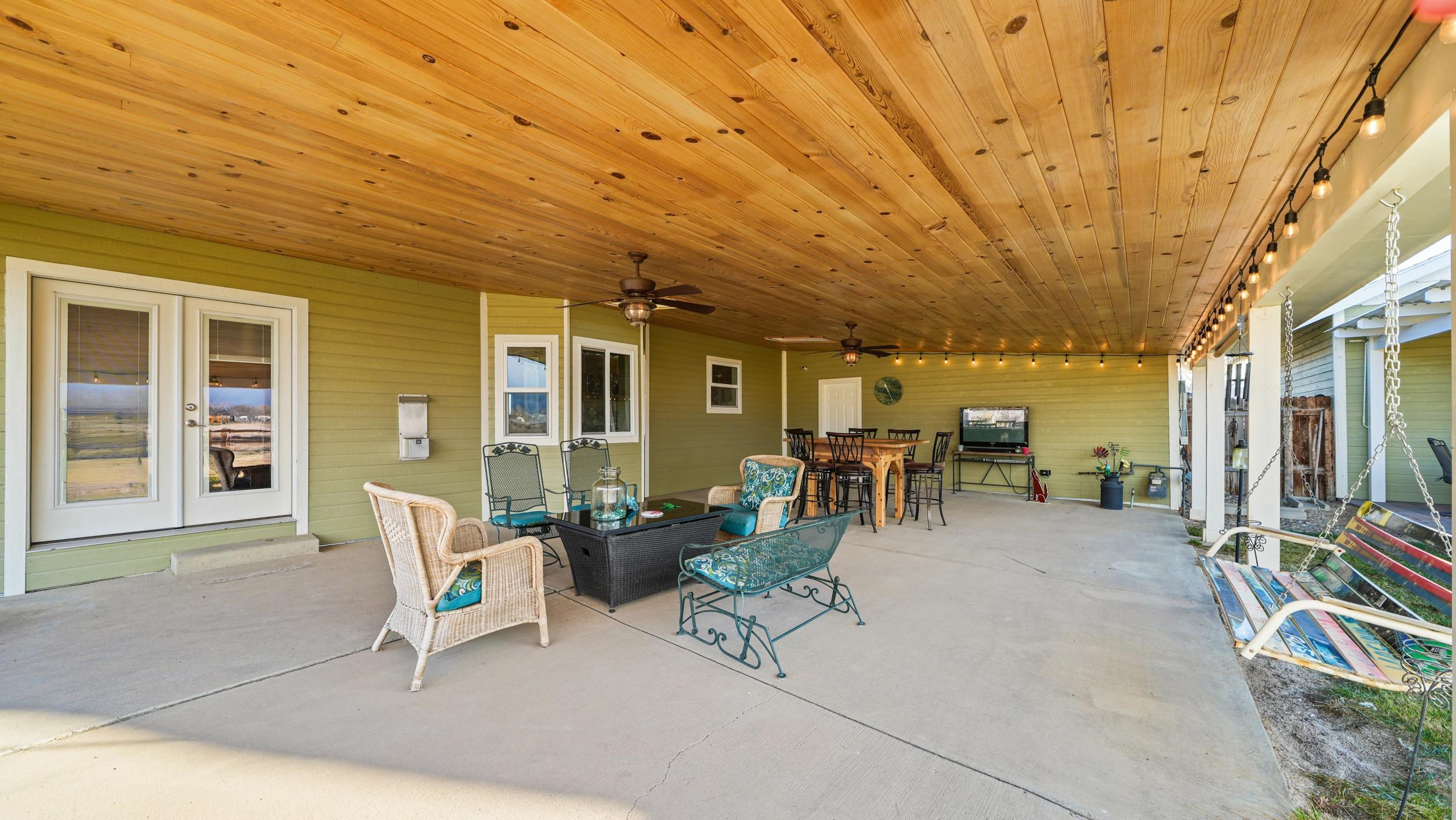 1392 M M 1/4 Road Loma, CO 81524 - Photo 26 of 42 a view of a patio with table and chairs and potted plants