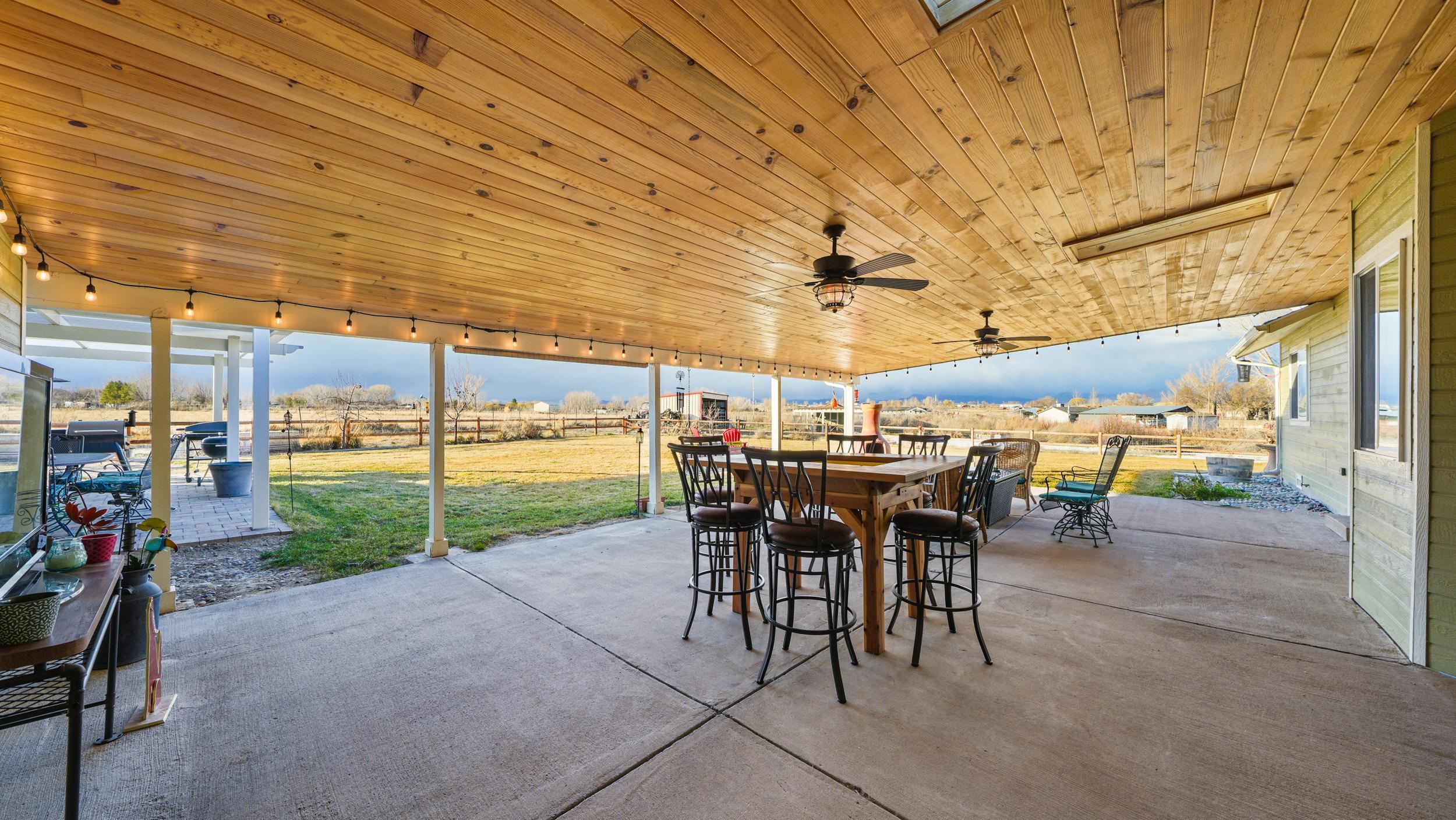 1392 M M 1/4 Road Loma, CO 81524 - Photo 27 of 42 a view of a patio with table and chairs and potted plants