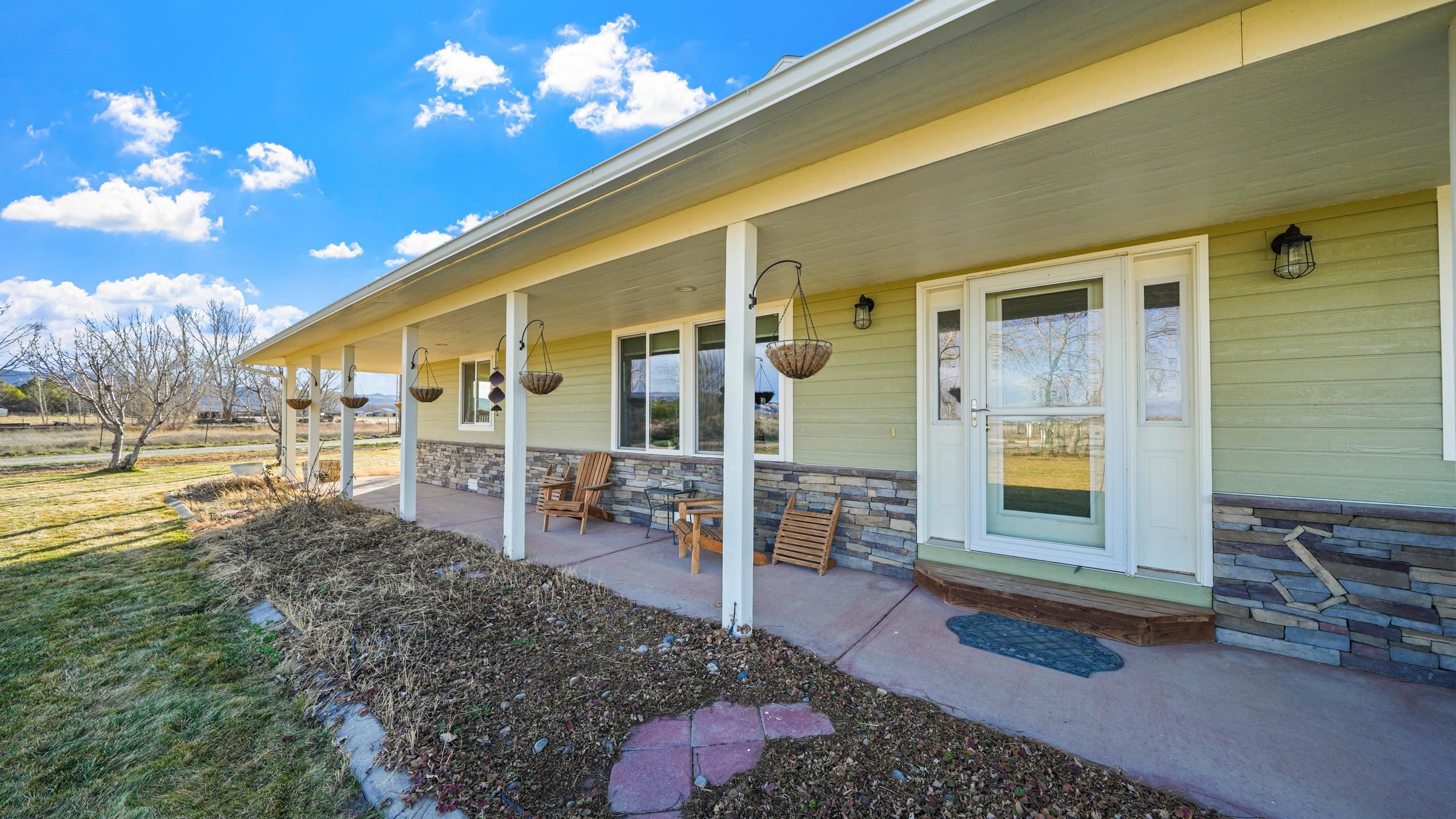 1392 M M 1/4 Road Loma, CO 81524 - Photo 30 of 42 a view of a chairs and table in backyard of the house