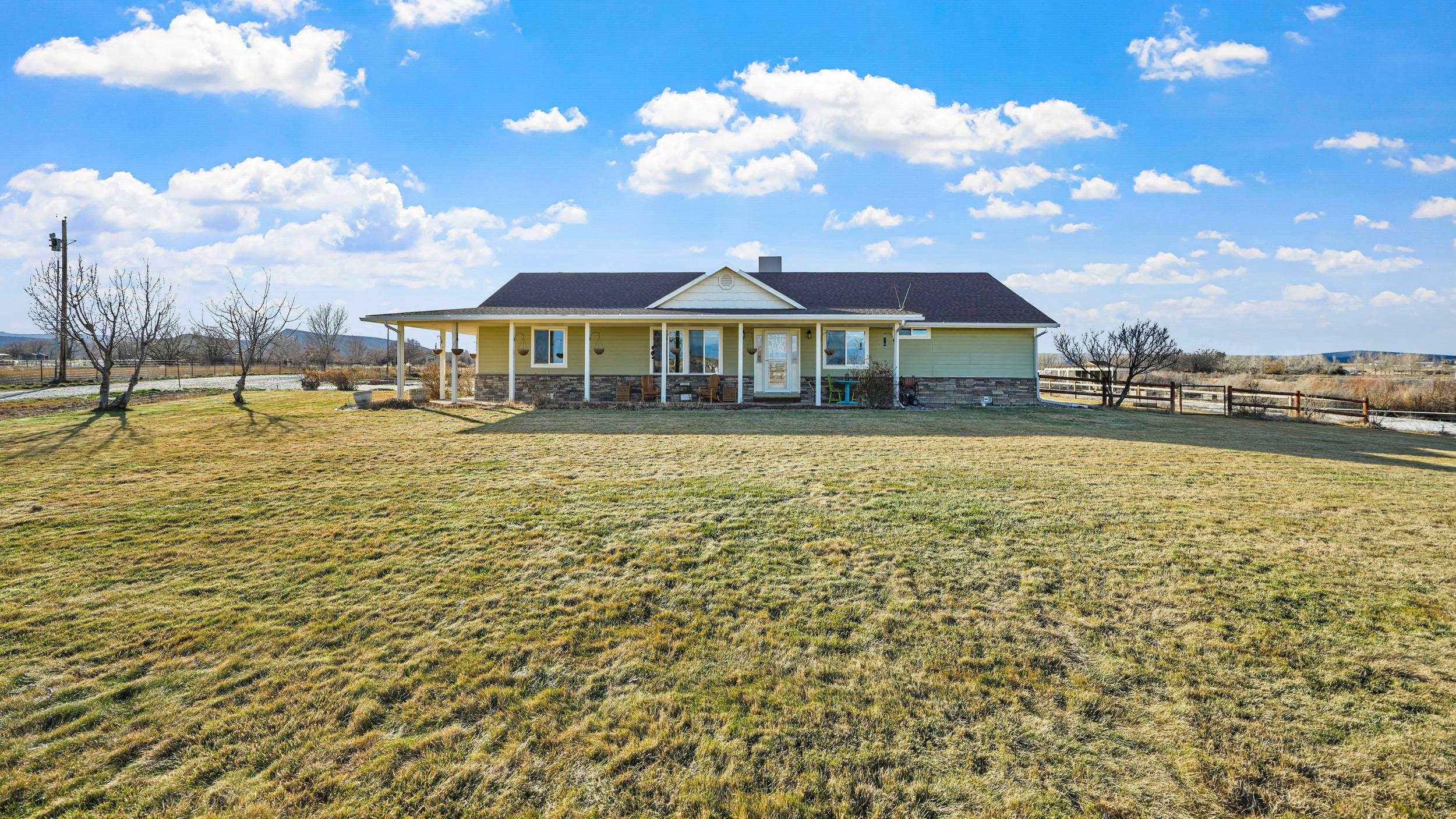1392 M M 1/4 Road Loma, CO 81524 - Photo 3 of 42 a house view with swimming pool and trees in front of it