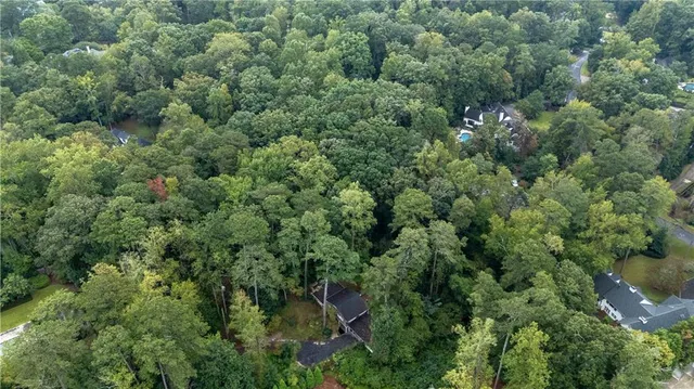 an aerial view of a house with a yard