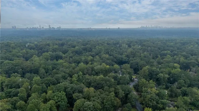 an aerial view of house with yard and mountain in the back