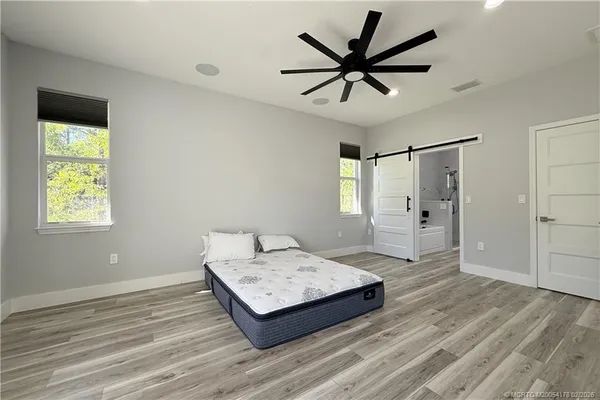 a living room with a bed furniture and a window
