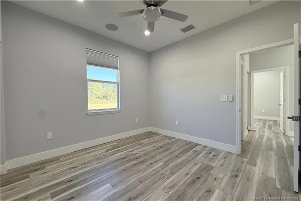 a bathroom with a granite countertop sink a toilet and a mirror