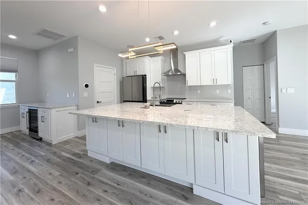 a kitchen with kitchen island granite countertop a sink and counter space