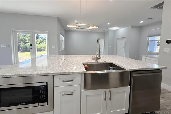 a kitchen with a sink and stainless steel appliances