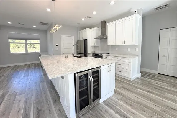 a very nice looking open kitchen with a large window