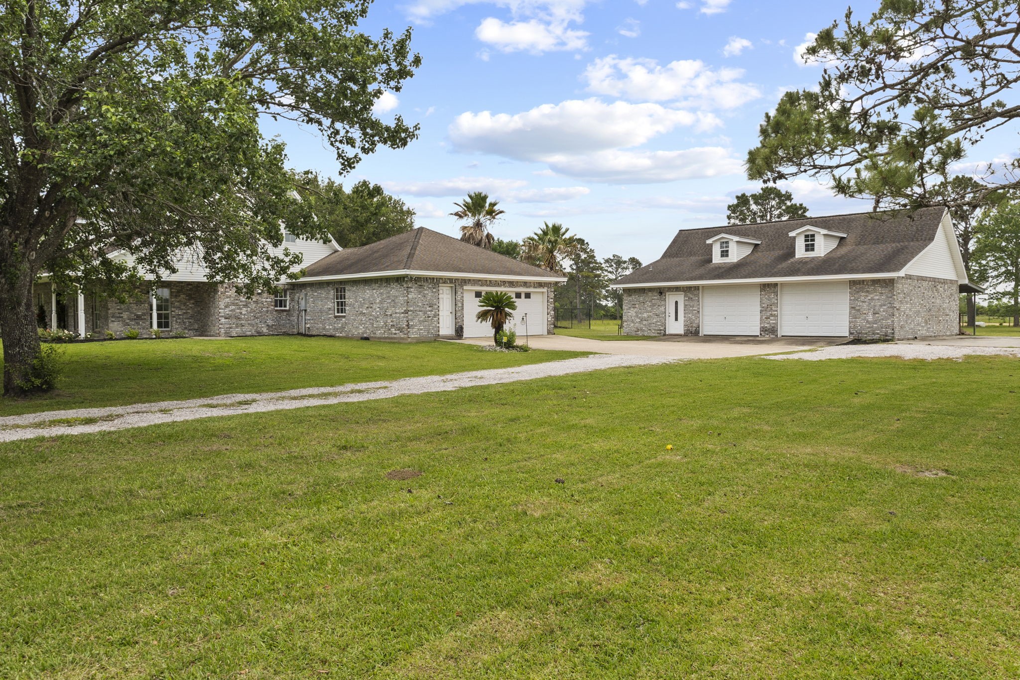 16421 Westbury Road Beaumont, TX 77713 - Photo 25 of 29 a view of a big house with a big yard and large trees