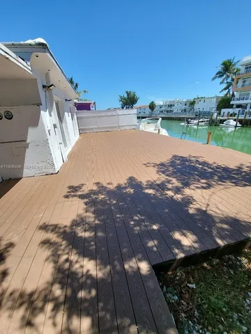 a view of a house with a wooden fence