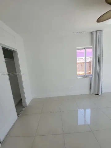 a view of a pathway of a yard with wooden fence