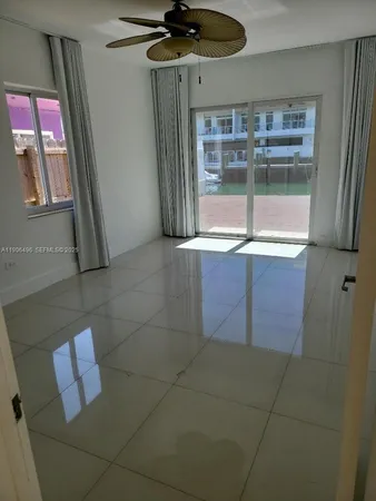 a kitchen with a sink a refrigerator and window