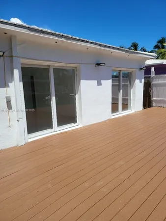 a view of a yard with wooden fence
