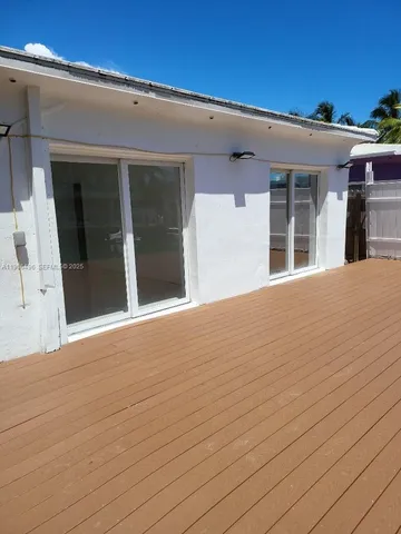 a view of a yard with wooden fence