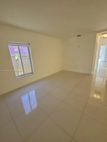 a white refrigerator freezer and a stove sitting inside of a kitchen