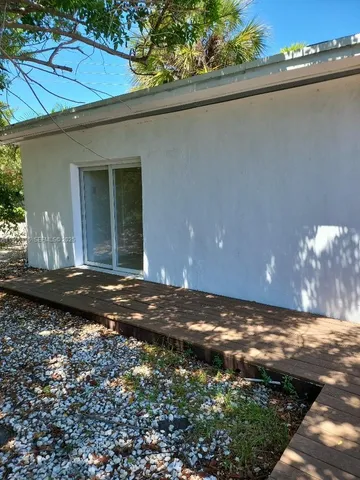 a bathroom with a window and a shower