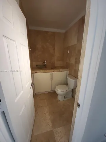 a bathroom with a granite countertop bathtub shower and toilet