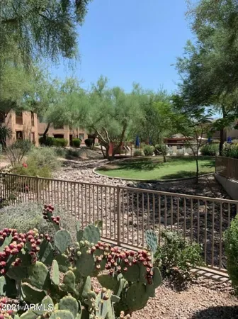 a view of swimming pool with a garden and trees