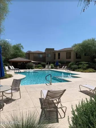 a swimming pool with outdoor seating and yard