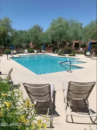 a view of backyard with seating area and trees around