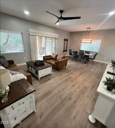 a living room with furniture and wooden floor