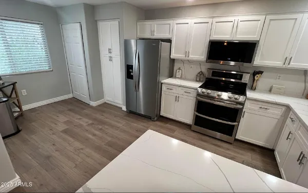 a kitchen with a refrigerator stove and microwave