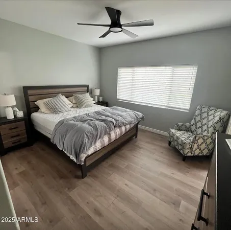 a bedroom with a bed couch and a window