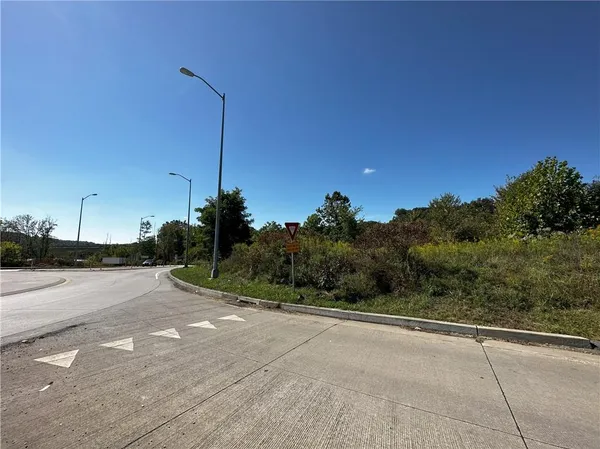 a view of a road with a building in the background