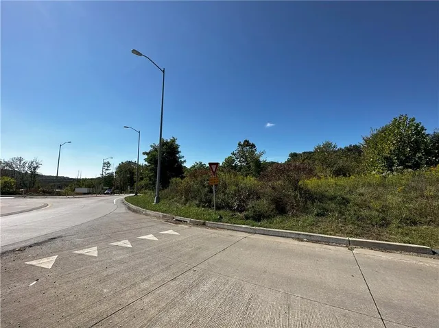 a view of a road with a building in the background