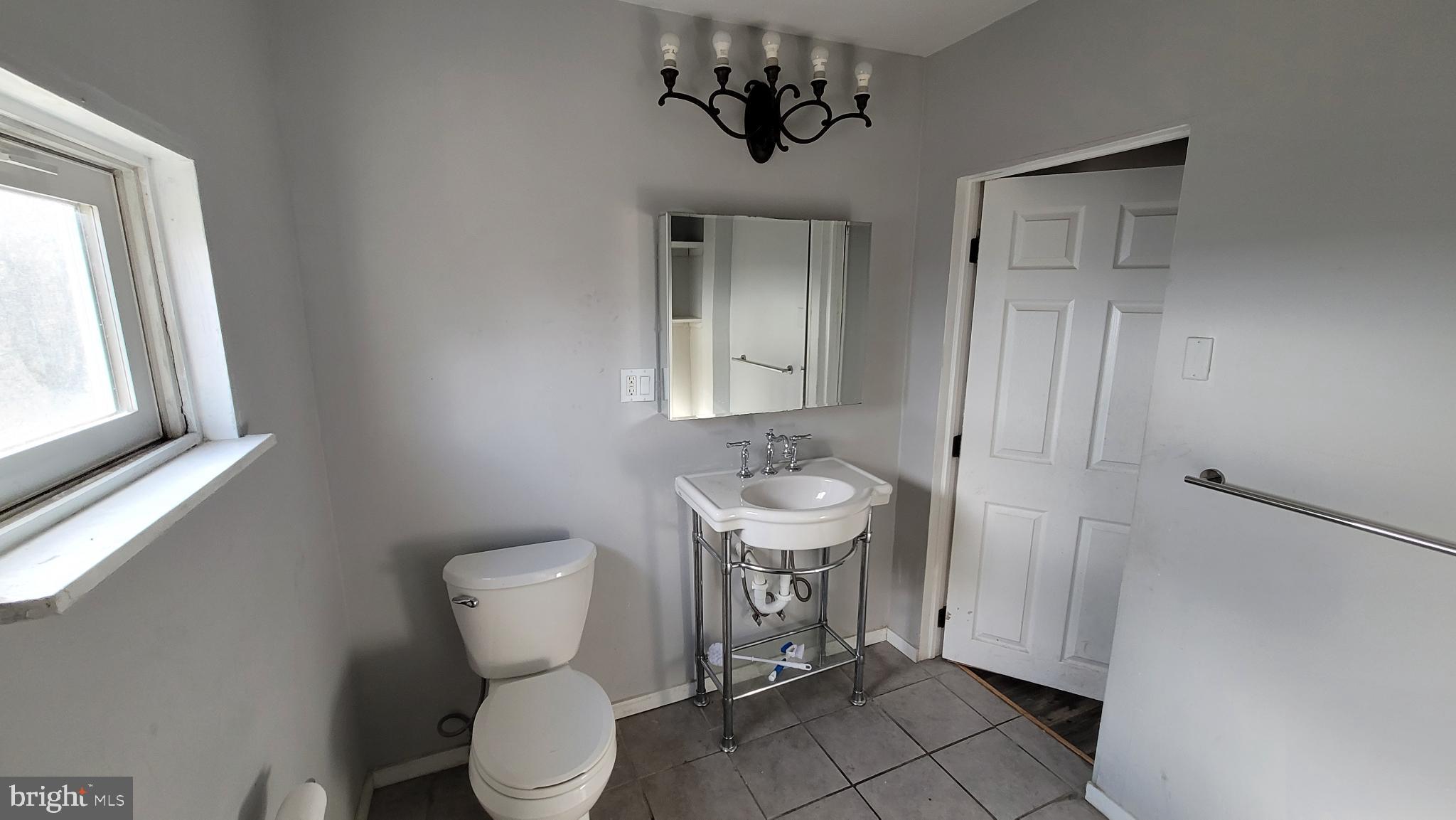 262 Indiana Avenue Shenandoah, PA 17976 - Photo 17 of 35 a bathroom with a toilet a sink and mirror