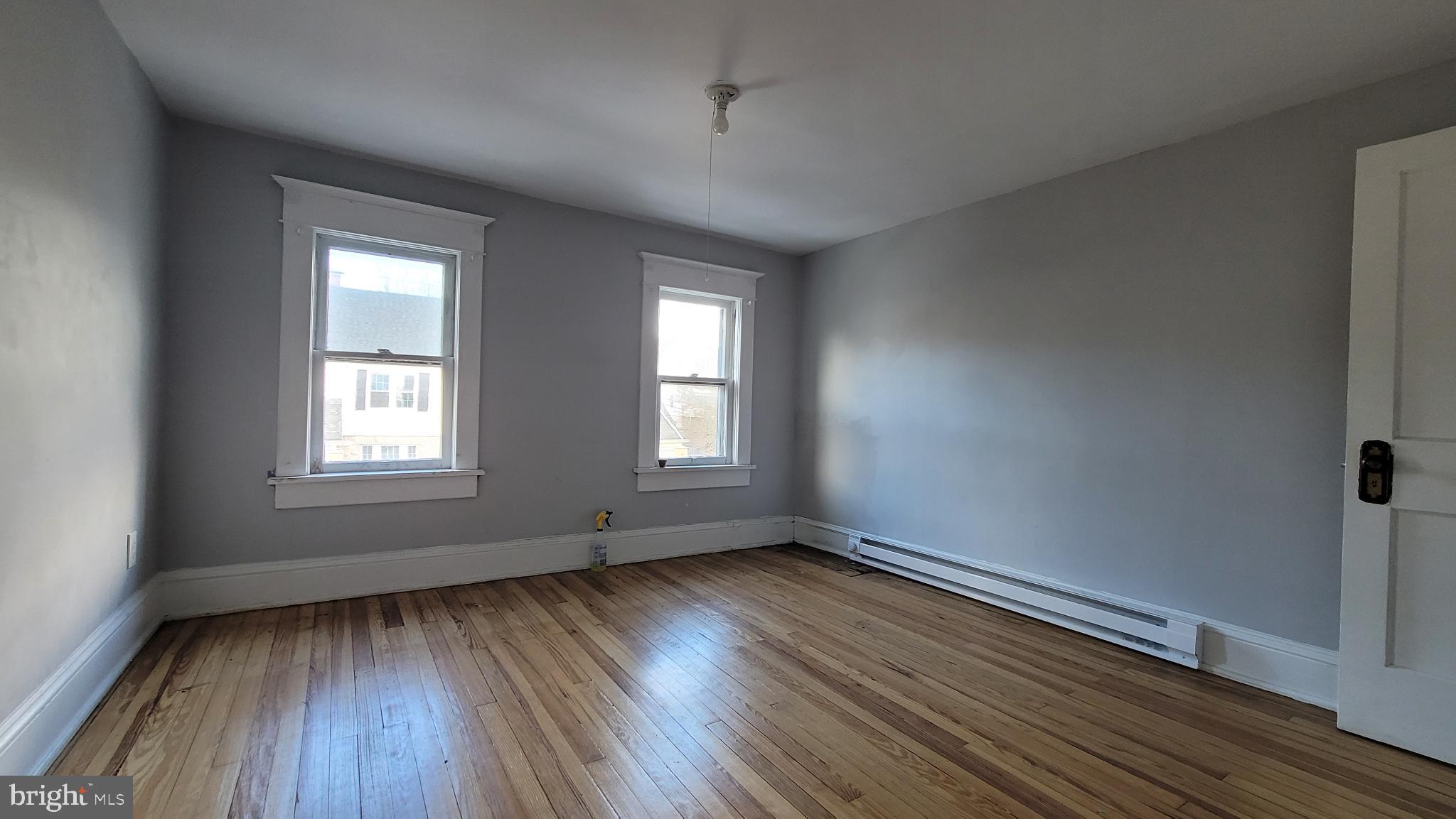 262 Indiana Avenue Shenandoah, PA 17976 - Photo 29 of 35 a view of an empty room with wooden floor and a window