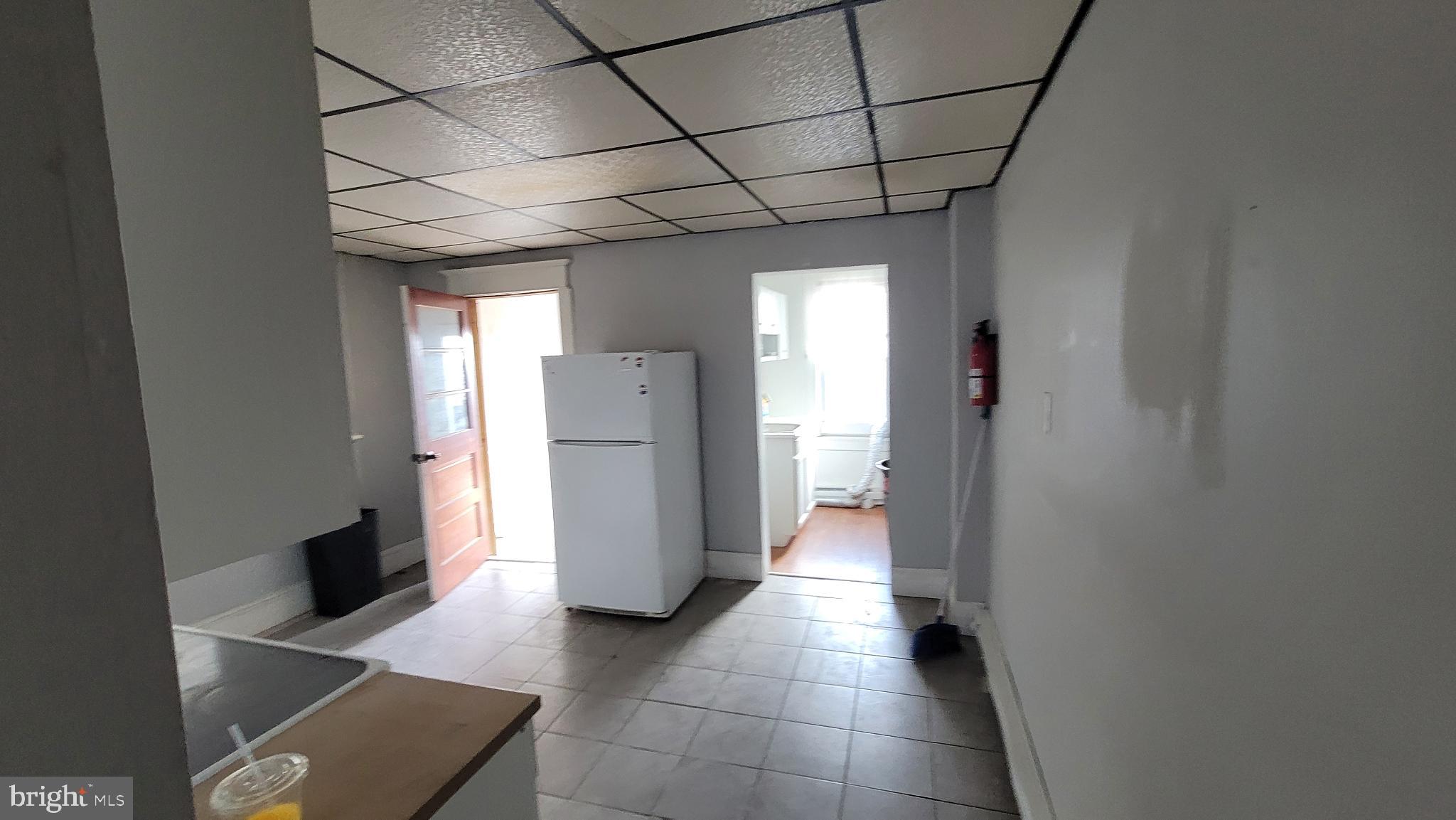 262 Indiana Avenue Shenandoah, PA 17976 - Photo 9 of 35 a view of a storage & utility room with refrigerator and washer
