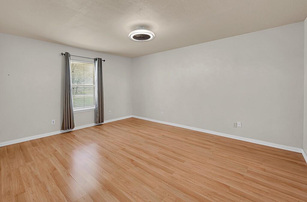 2857 Country Spring Road Lorena, TX 76655 - Photo 14 of 40 Spare room with light wood finished floors and a textured ceiling