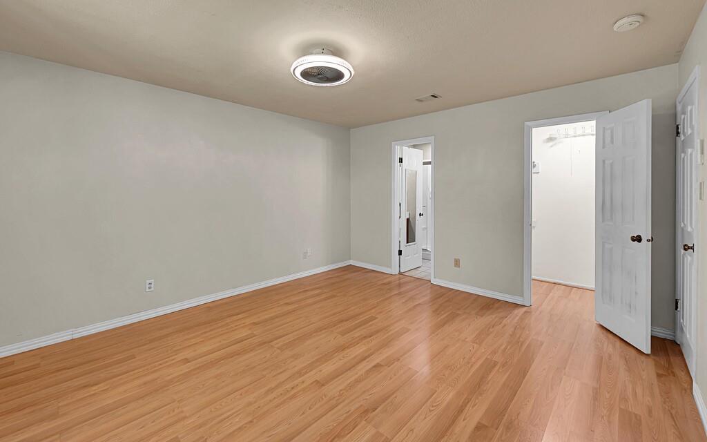 2857 Country Spring Road Lorena, TX 76655 - Photo 15 of 40 Unfurnished bedroom featuring a walk in closet and light wood finished floors