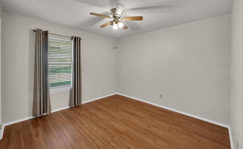 2857 Country Spring Road Lorena, TX 76655 - Photo 18 of 40 Empty room featuring a textured ceiling, wood finished floors, and ceiling fan