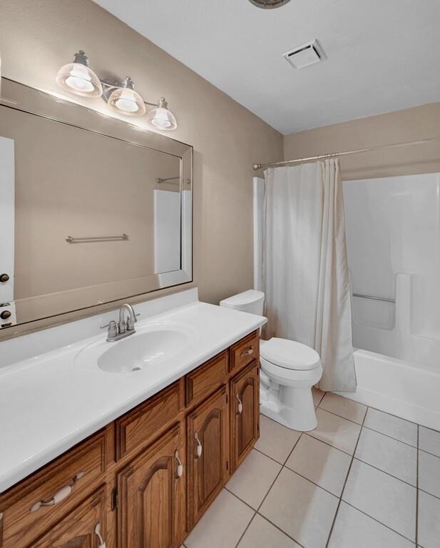 2857 Country Spring Road Lorena, TX 76655 - Photo 19 of 40 Bathroom with vanity, shower / bath combination with curtain, and light tile patterned floors