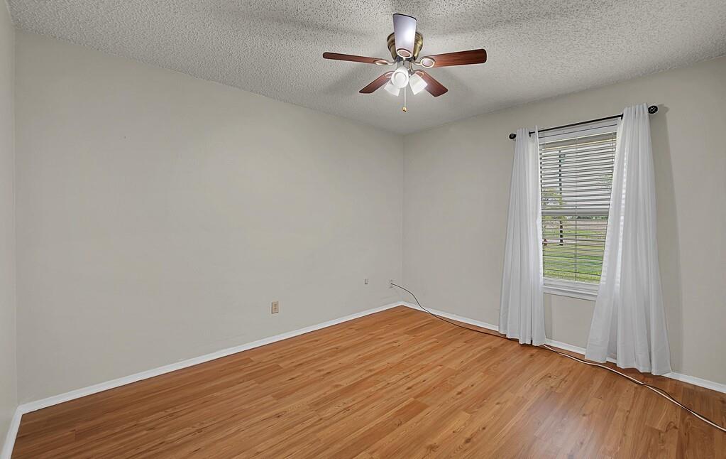 2857 Country Spring Road Lorena, TX 76655 - Photo 20 of 40 Empty room featuring a textured ceiling, light wood-type flooring, and ceiling fan